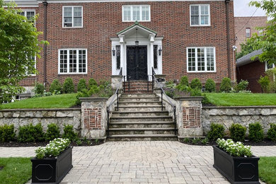 This is an example of a medium sized traditional front formal garden in New York.