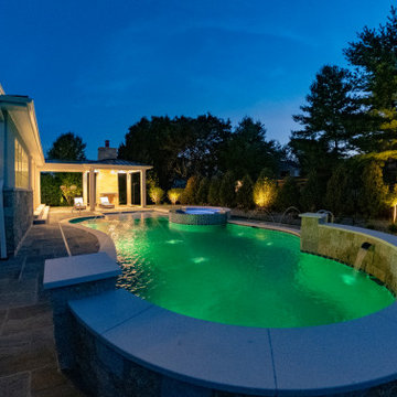 Naperville, IL freeform swimming pool with hot tub, large sunshelf, glass tile