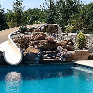 Estate Poolside Landscape & Hardscape Retreat with Custom Waterfeature