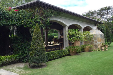 Mid-sized traditional backyard patio in Miami with an outdoor kitchen and a pergola.
