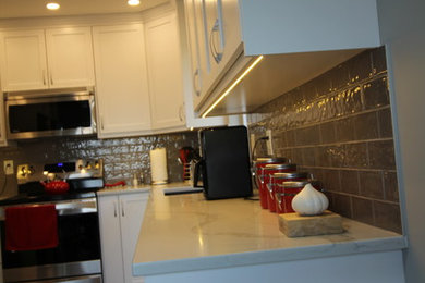 Eat-in kitchen - mid-sized contemporary vinyl floor and gray floor eat-in kitchen idea in Vancouver with an undermount sink, shaker cabinets, white cabinets, quartzite countertops, gray backsplash, porcelain backsplash and stainless steel appliances
