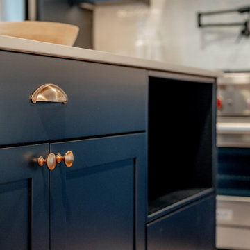 Navy Shaker Cabinets with Polished Brass Cup Pulls and Knobs