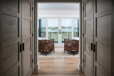Family room - mid-sized contemporary enclosed light wood floor and brown floor family room idea in Other with white walls, no fireplace and no tv