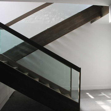 Modern Staircase with wooden frame glass railing