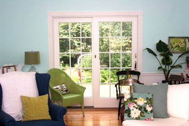 Example of a light wood floor living room design in Philadelphia with blue walls