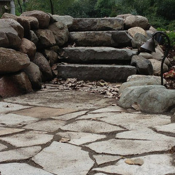 Flagstone patio with boulder wall