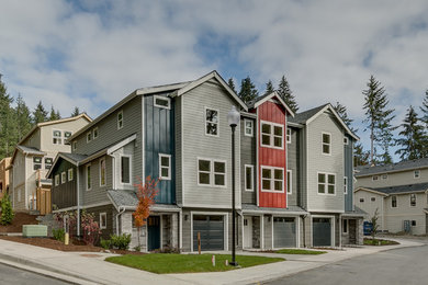 Mid-sized minimalist multicolored three-story concrete fiberboard exterior home photo in Seattle with a shingle roof
