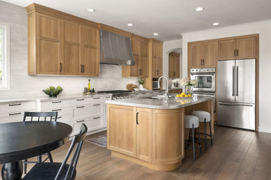 Mid-sized transitional l-shaped vinyl floor and brown floor eat-in kitchen photo in San Diego with an undermount sink, shaker cabinets, light wood cabinets, quartzite countertops, white backsplash, ceramic backsplash, stainless steel appliances, an island and gray countertops