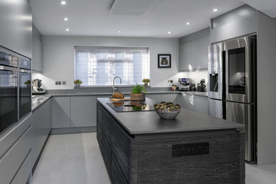 Photo of a contemporary kitchen in Berkshire with integrated appliances and an island.