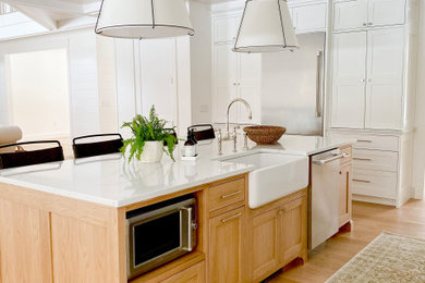 Example of a large transitional l-shaped light wood floor and shiplap ceiling eat-in kitchen design in Boston with a farmhouse sink, recessed-panel cabinets, white cabinets, quartzite countertops, white backsplash, stone slab backsplash, an island and white countertops