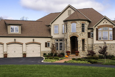 Large mountain style beige two-story mixed siding gable roof photo in Columbus