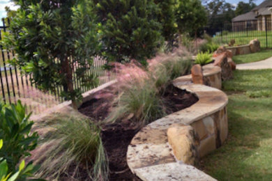 Inspiration for a mid-sized traditional backyard landscaping in Houston.