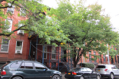 This is an example of a red traditional terraced house in New York with four floors.