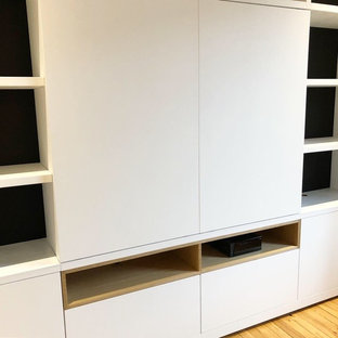 Inspiration for a large contemporary light wood floor home theater remodel in Toulouse with black walls and a wall-mounted tv