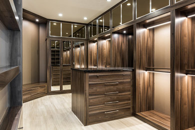 Design ideas for a large modern men's walk-in wardrobe in Miami with flat-panel cabinets.