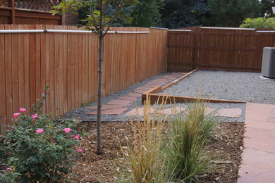 Design ideas for a mid-sized traditional full sun backyard stone landscaping in Denver.