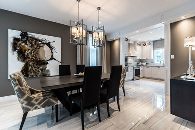 Example of a large trendy ceramic tile and gray floor kitchen/dining room combo design in Montreal with gray walls and no fireplace