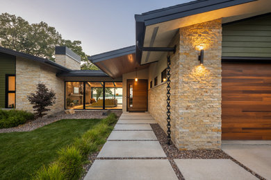 Mid-sized 1960s multicolored one-story mixed siding exterior home photo in Other with a shingle roof and a black roof