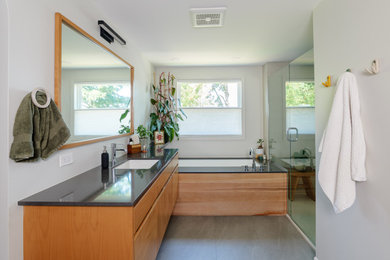 Bathroom - large modern master green tile and porcelain tile vinyl floor, gray floor and single-sink bathroom idea in Portland with flat-panel cabinets, medium tone wood cabinets, an undermount tub, white walls, an undermount sink, quartz countertops, a hinged shower door, black countertops and a floating vanity