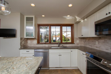 Inspiration for a mid-sized timeless u-shaped ceramic tile and brown floor eat-in kitchen remodel in Other with an undermount sink, recessed-panel cabinets, white cabinets, quartz countertops, multicolored backsplash, stone tile backsplash, stainless steel appliances and an island