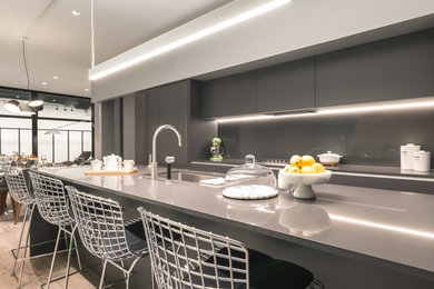 Inspiration for a mid-sized modern kitchen in Chicago with flat-panel cabinets, grey cabinets, quartz benchtops, with island and grey benchtop.