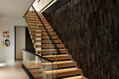 Staircase - large contemporary floating glass railing and wallpaper staircase idea in Boston
