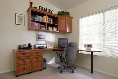 Example of a mid-sized classic built-in desk carpeted, white floor and vaulted ceiling home office design in Orange County with white walls