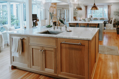 Example of a single-wall eat-in kitchen design in Philadelphia with medium tone wood cabinets, two islands and white countertops