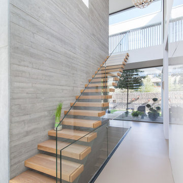 Villa Y - Raumteiler mit Kragarmtreppe im Erdgeschoss