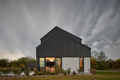 Example of a large trendy multicolored two-story metal gable roof design in Toronto with a metal roof and a black roof