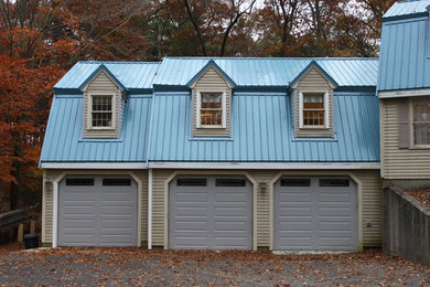 This is an example of a large traditional attached three-car garage in Boston.