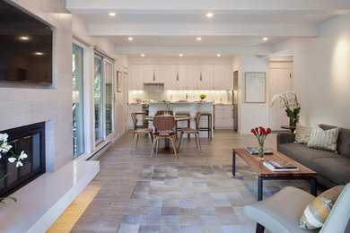 Mid-sized transitional open concept living room photo in Denver with white walls, a standard fireplace, a tile fireplace and a wall-mounted tv
