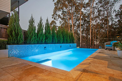 Design ideas for a mid-sized contemporary backyard rectangular aboveground pool in Brisbane with a water feature and tile.