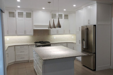 Inspiration for a mid-sized transitional u-shaped ceramic tile and beige floor open concept kitchen remodel in Toronto with shaker cabinets, white cabinets, granite countertops, white backsplash, subway tile backsplash, stainless steel appliances and an island