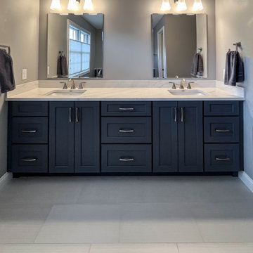 Primary Bathroom with Blue-Gray Vanity and Deep Blue Tiled Feature Wall