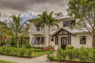 Large coastal white two-story exterior home idea in Miami