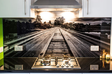 This is an example of a mid-sized traditional galley separate kitchen in Sydney with glass tile splashback.