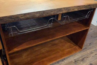 Inspiration for a large cottage u-shaped medium tone wood floor and brown floor kitchen pantry remodel in Omaha with open cabinets, medium tone wood cabinets, wood countertops, stainless steel appliances, a peninsula and brown countertops