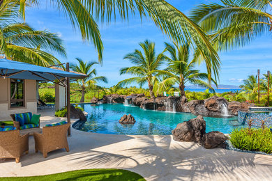 Inspiration for a large courtyard stone and custom-shaped natural hot tub remodel in Hawaii