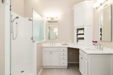 Alcove shower - small transitional master gray tile and ceramic tile ceramic tile alcove shower idea in Dallas with an undermount sink, raised-panel cabinets, white cabinets, marble countertops, a one-piece toilet and gray walls