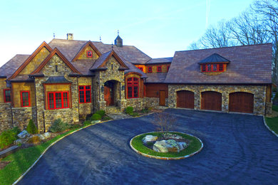 Inspiration for a huge craftsman gray three-story stone house exterior remodel in Charlotte with a shingle roof