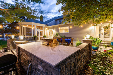 This is an example of a large contemporary back patio in DC Metro with a fire feature.