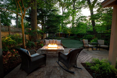 Inspiration for a contemporary backyard brick and wood fence landscaping in Toronto.