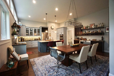 Inspiration for a large contemporary l-shaped dark wood floor, brown floor and vaulted ceiling open concept kitchen remodel in Columbus with shaker cabinets, gray cabinets, granite countertops, multicolored backsplash, glass tile backsplash, stainless steel appliances, an island, black countertops and a single-bowl sink