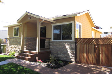 Small arts and crafts yellow one-story wood gable roof photo in San Francisco