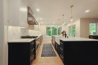 Inspiration for a mid-sized brown floor eat-in kitchen remodel in Seattle with blue cabinets, quartzite countertops, white backsplash, quartz backsplash, stainless steel appliances, an island and white countertops