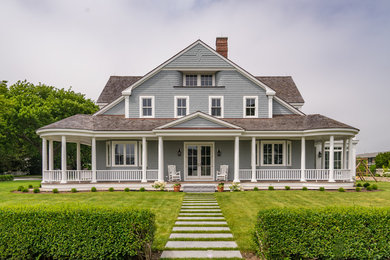 Example of a beach style home design design in Portland Maine