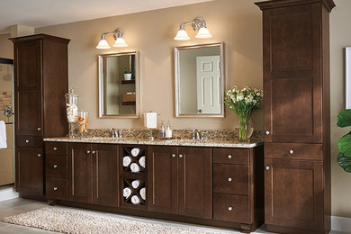 Example of a large transitional master porcelain tile and gray floor bathroom design in New York with shaker cabinets, dark wood cabinets, beige walls, an undermount sink, granite countertops and brown countertops