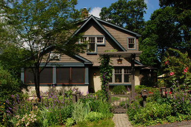 Inspiration for a mid-sized arts and crafts two-storey brown house exterior in New York with wood siding, a gable roof and a shingle roof.