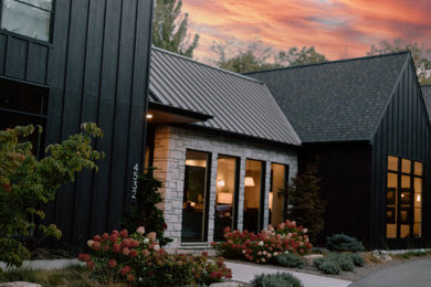 Scandinavian black two-story wood and board and batten exterior home idea in Grand Rapids with a shingle roof and a gray roof